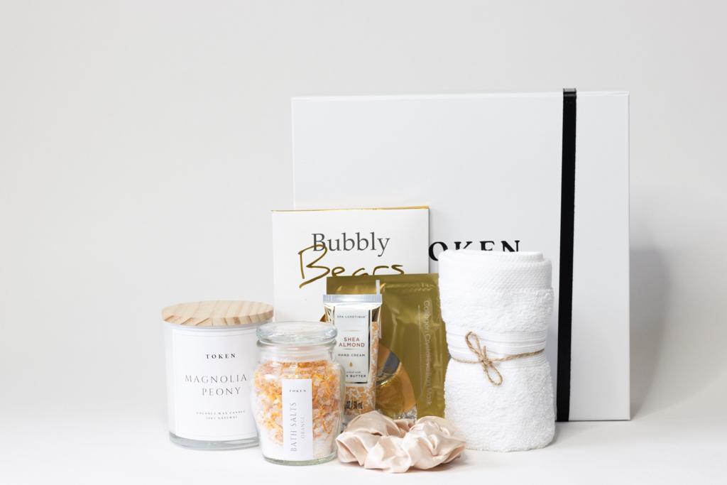 Spoil Her Gift Box. Includes: Coconut Candle, Bath Salts, Face Cloth, Champagne Gummies, Hand Cream, Eye Mask and Scrunchie 